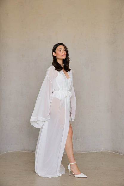 Angel Robe - walking motion shot, front slit reveals leg as fabric billows