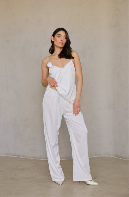 Model wearing Ivory Rose satin pants, full front view in relaxed bridal-lounge pose